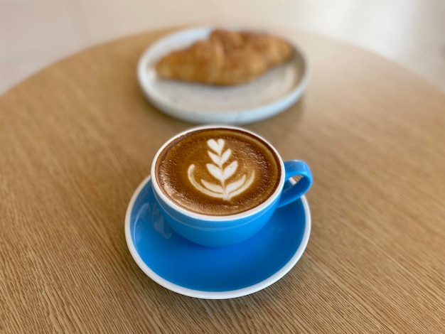 Tazza di caffè calda e croissant sul tavolo