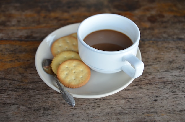 tazza di caffè con cookie per la colazione su fondo di legno