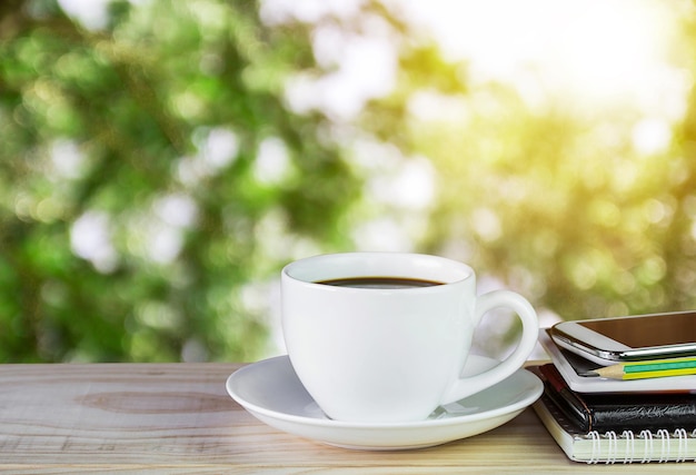 Tazza di caffè con immagine sfocata di bokeh astratto di colore verde albero