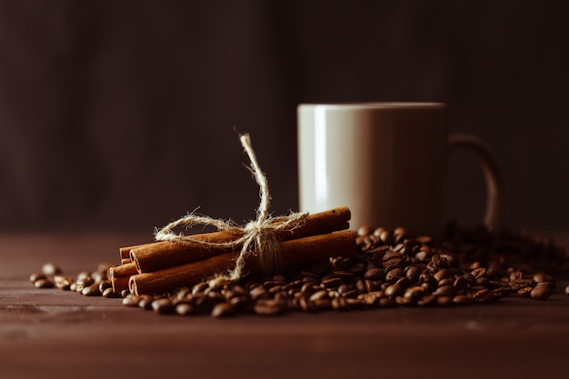 Tazza di caffè con un sacco di tela di fagioli arrostiti sul tavolo rustico