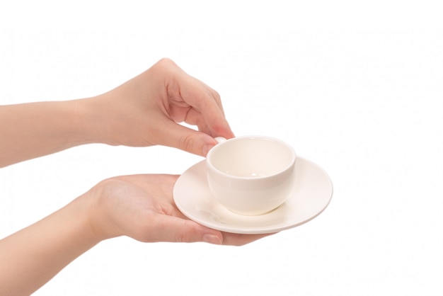 Tazza di caffè vuota in mano della donna isolata su bianco.