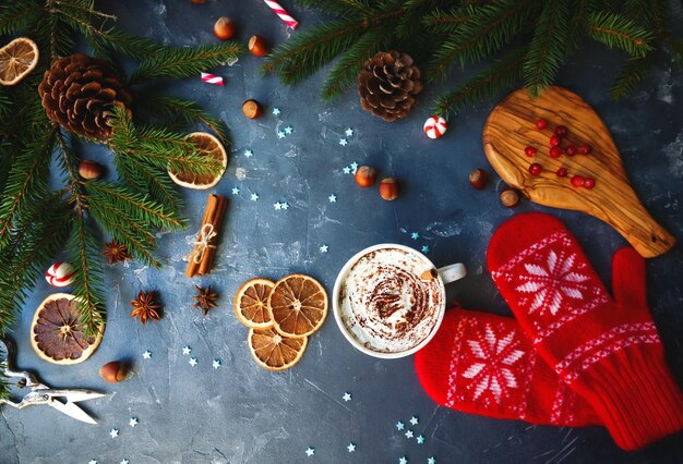 Tazza di cioccolata calda o cacao con crema alla vaniglia decorazione natalizia per la casa su sfondo di pietra scura