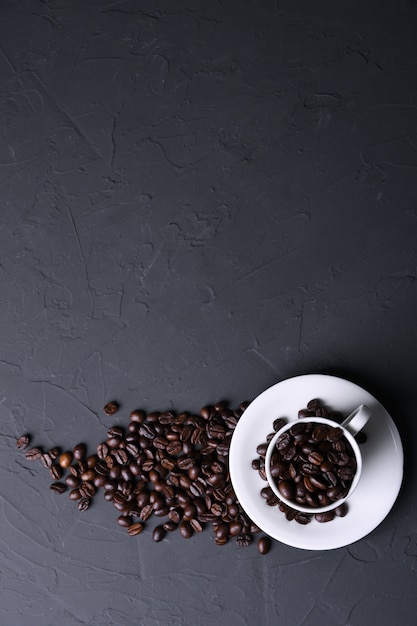 Tazza e fagioli di caffè sul vecchio beton grigio della cucina, tavola della roccia. Vista dall'alto con copyspace