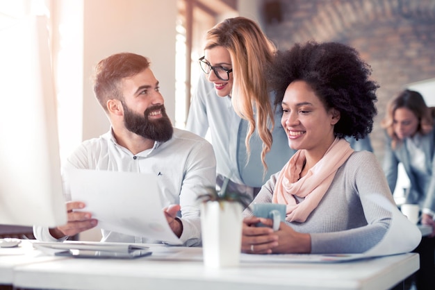 Team di giovani architetti che lavorano su piani di costruzione