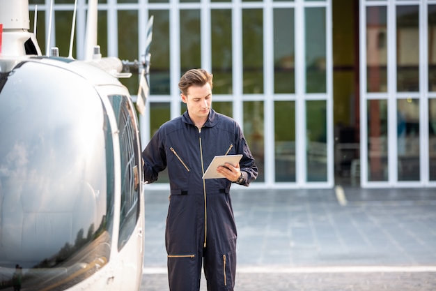 tecnico dell'elicottero che sta contro l'elicottero in aeroporto