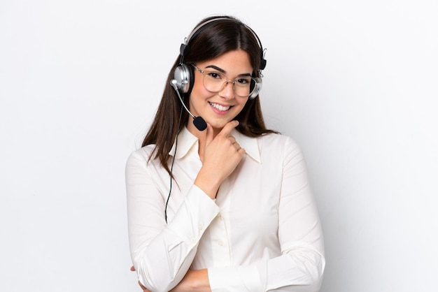 Telemarketer donna caucasica che lavora con un auricolare isolato su sfondo bianco con occhiali e sorridente