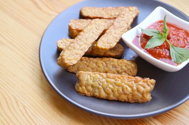 Tempeh al forno con salsa marinara fatta in casa Un piatto sano e gustoso della dieta a base vegetale di cibi integrali