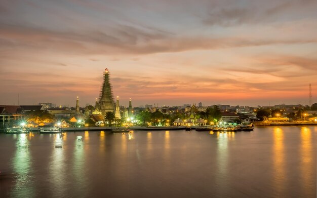 Tempio dell'alba pagoda principale lato del fiume Chaophraya sotto il cielo serale crepuscolare a Bangkok in Thailandia