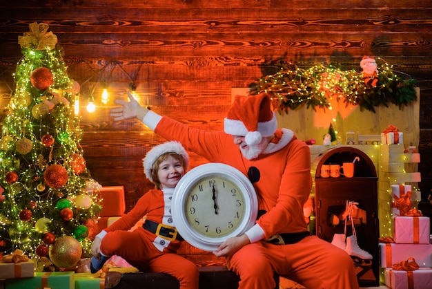 Tempo per natale natale ragazzo con orologio capodanno mezzanotte buon natale bambino ragazzo vestito come