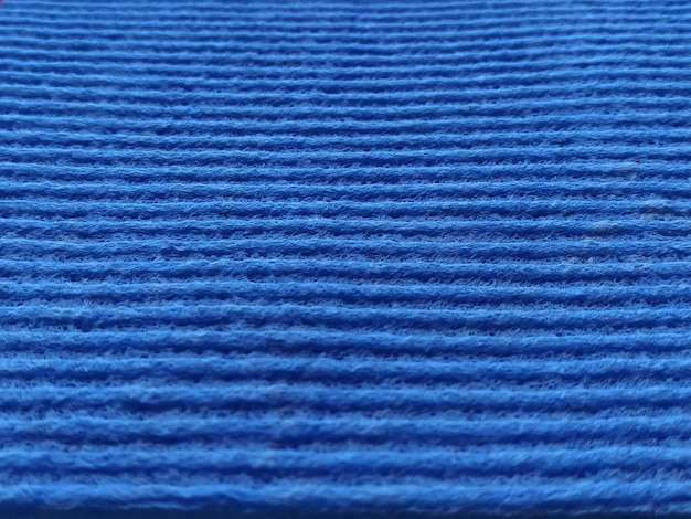 Tessuto a costine a righe blu Primo piano di una spugna per lavare i piatti o un panno in microfibra Sfocatura attorno ai bordi