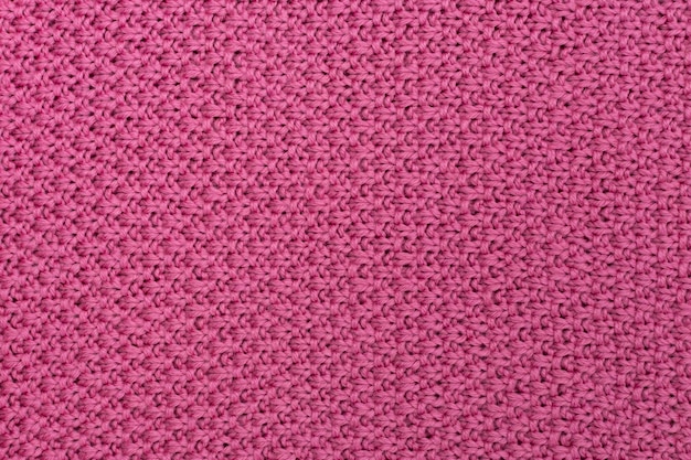 Tessuto a maglia rosa sfondo di lana perla La struttura del tessuto con una trama naturale Tessuto di fondo Sfondo di lana a maglia