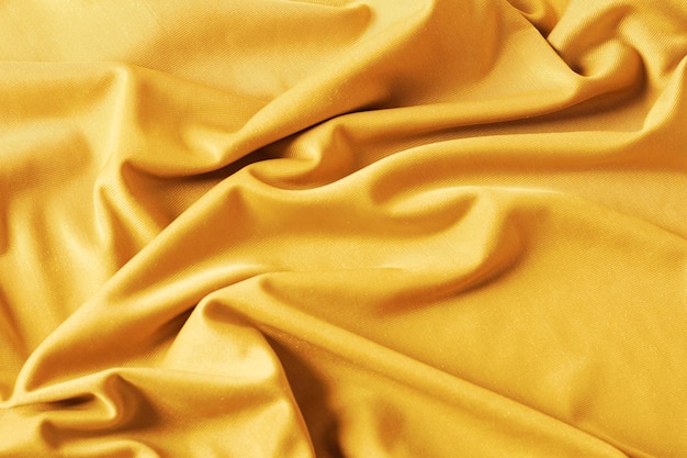 Tessuto in velluto drappeggiato in colore giallo dorato alla moda Sfondo moderno astratto