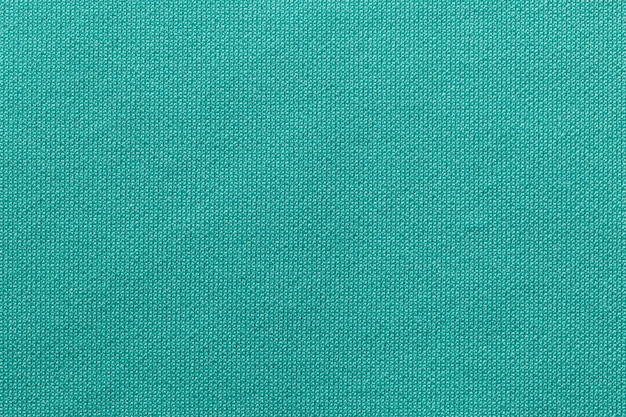 Tessuto per abbigliamento sportivo di colore verde la trama di una maglia da calcio e un fondo tessile