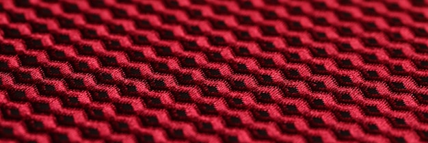 Tessuto rosso e nero con ornamento geometrico primo piano di tessuto con motivo a zig-zag