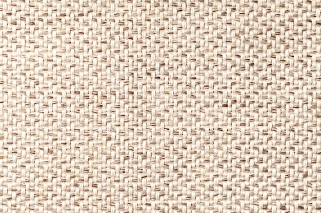 Tessuto vintage beige con trama tessuta closeup. Sfondo a macroistruzione tessile