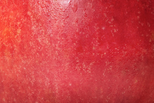 Testura di una mela rossa e gialla come sfondo Frutta di cibo sano Foto macro di una mela