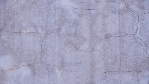 Texture delle pareti rotte fondo del pavimento in cemento facciata in gesso parete della casa con crepe scure grigie sfondo astratto