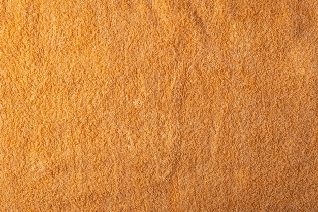 Texture di asciugamano arancione vicino alla vista dall'alto