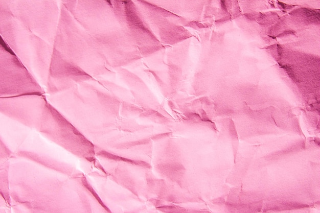 Texture di carta stropicciata rosa che è sgualcita e strutturata.