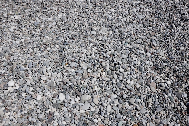 Texture di ciottoli dalla spiaggia della riva del mare