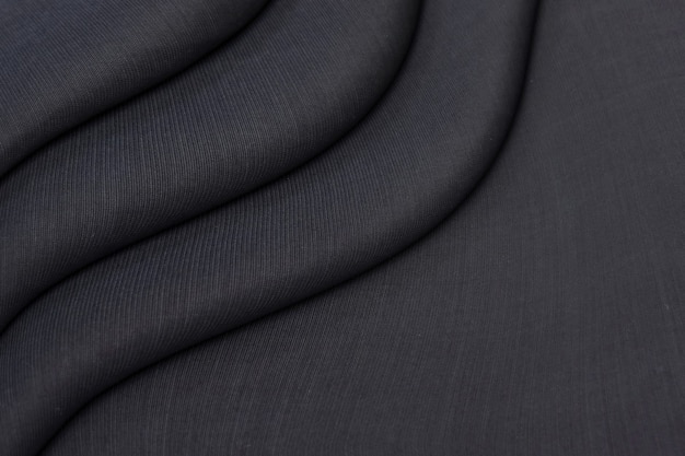Texture di drappeggi di maglieria nera stropicciata