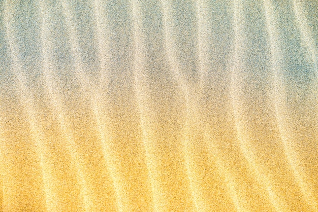 Texture di dune di sabbia del deserto grigio giallo. Può essere utilizzato come sfondo naturale