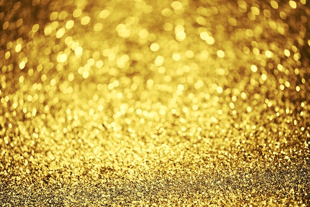 Texture di illuminazione bokeh glitter dorato Sfondo astratto sfocato per compleanno anniversario matrimonio capodanno o Natale