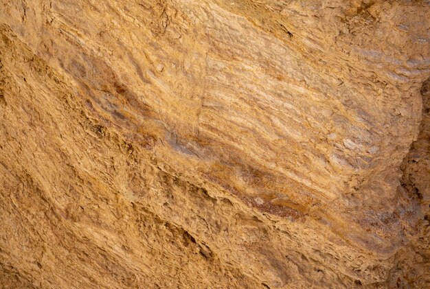 Texture di pietra arancione e concetto di geologia di fondo