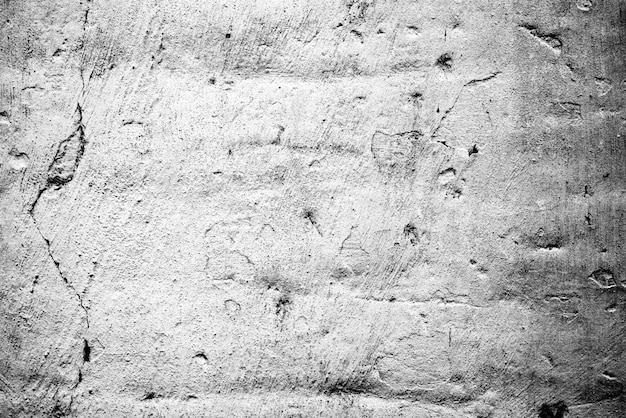 Texture di un muro di cemento con crepe e graffi sullo sfondo