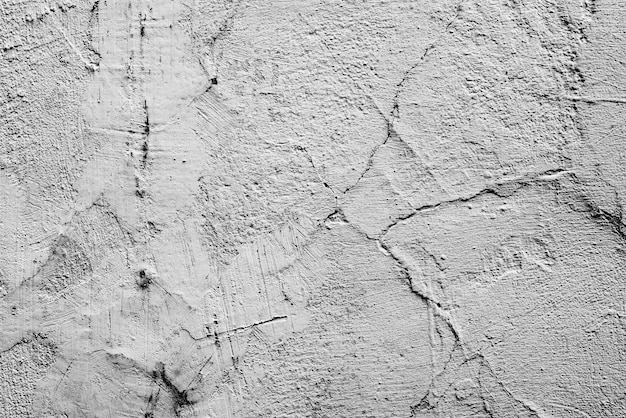 Texture di un muro di cemento con crepe e graffi