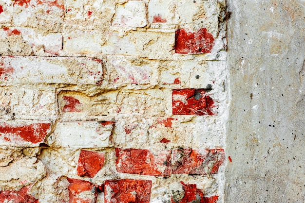 Texture di un muro di mattoni con crepe e graffi che può essere utilizzato come sfondo