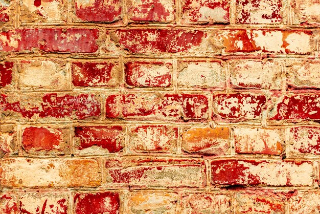 Texture di un muro di mattoni con crepe e graffi che può essere utilizzato come sfondo