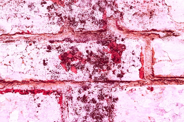 Texture di un muro di mattoni con crepe e graffi che può essere utilizzato come sfondo