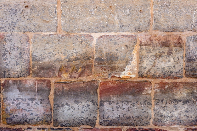 Texture di un muro di mattoni in pietra senza finitura