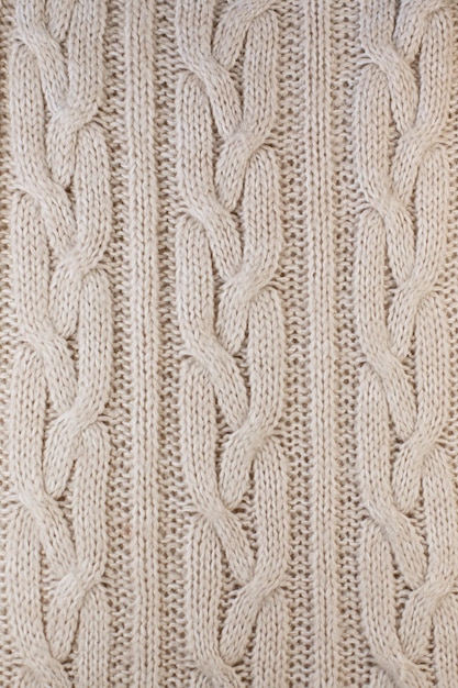 Texture di una grossa maglia di primo piano caldo maglione beige. il posto per il tuo mockup invernale