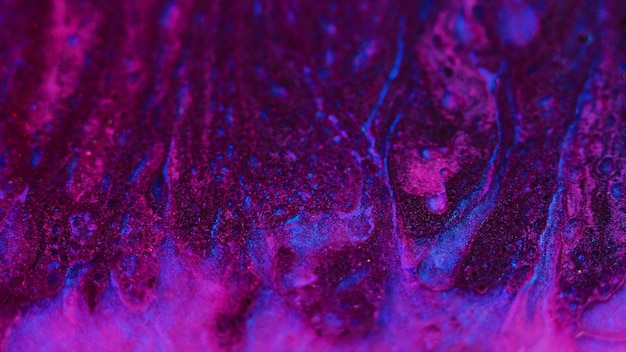 Texture di vernice luccicante flusso di fluido dell'olio miscela rosa-blu