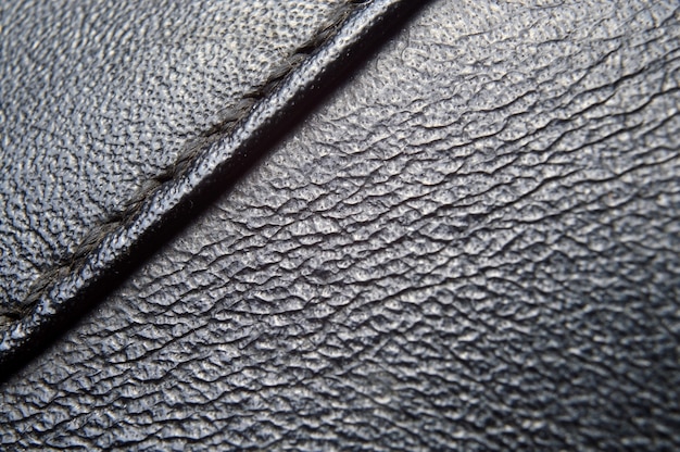 Texture in pelle nera con una cucitura