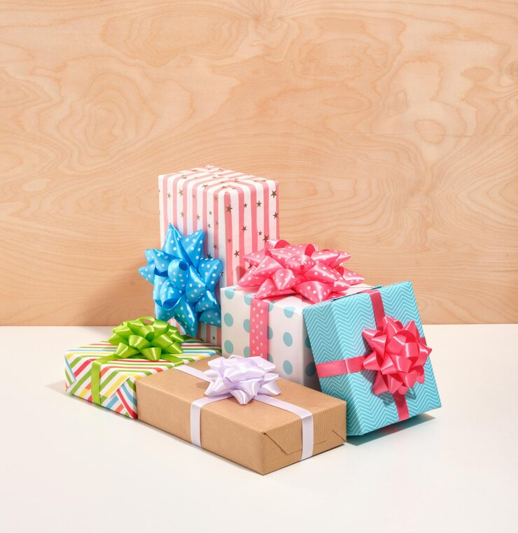 Photo the concept of holidays and greeting cards gifts are wrapped in colored gift paper with different beautiful designs colored festive bows in different sizes