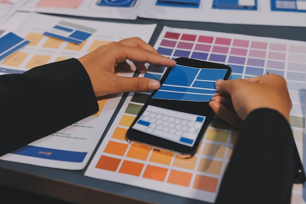 the designer team is designing the uxui system to make the uxui system work well on new phones and support system updates website development concept ui ux front end designer
