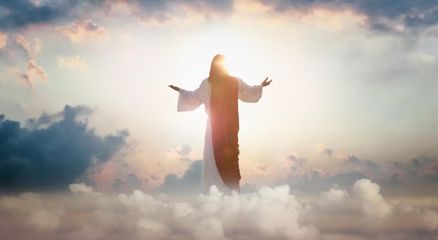 The resurrected Jesus Christ ascending to heaven above the bright light sky and clouds and God, Heav