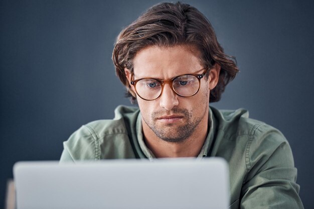 Thinking laptop and business man in office for working on web design online project and planning Creative startup IT technician and person on computer for research website and programming code
