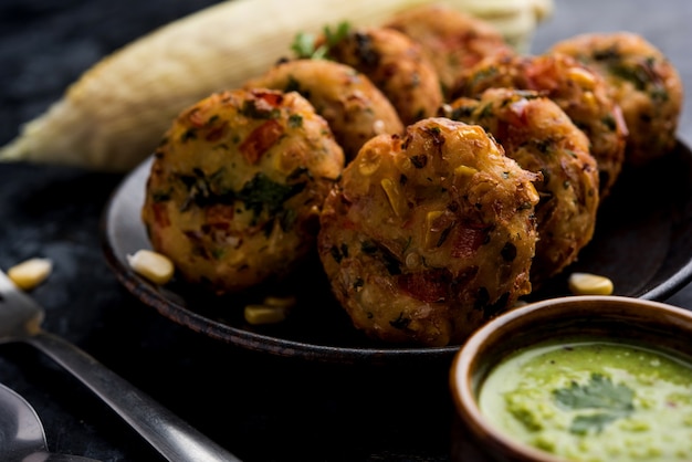 Tikki di mais croccante, pakora o pakoda o pattice noto anche come cotoletta. servito con chutney verde. Messa a fuoco selettiva