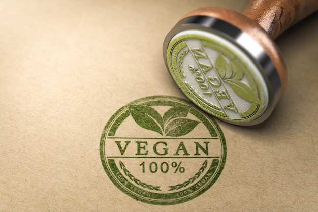 Timbro di gomma con il testo 100% vegan stampato su sfondo di cartone. illustrazione 3D.