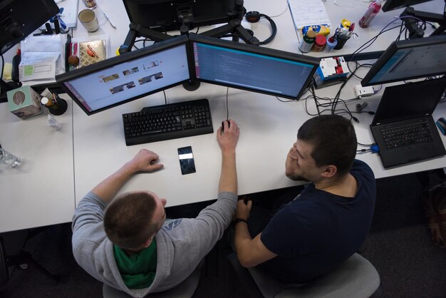 top view of software developers writing programming code on computer