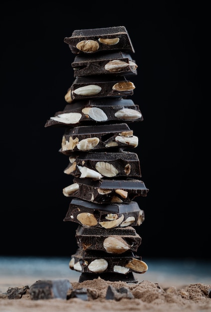 Torre di cioccolato con mandorle su sfondo nero