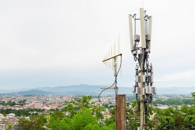 Torre per telecomunicazioni con antenna di rete cellulare 5G su una città sullo sfondo della valle