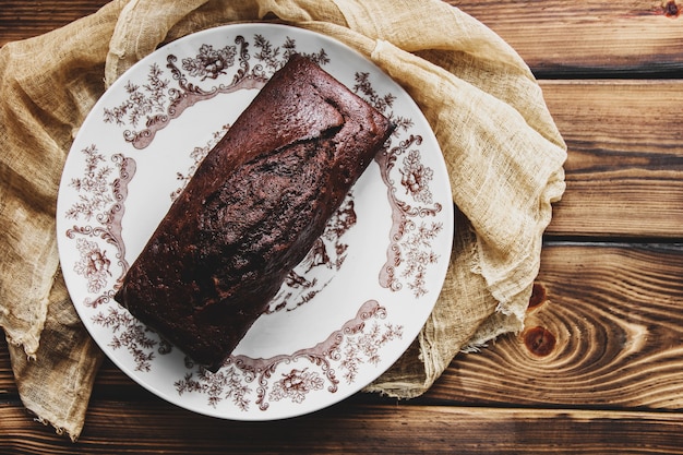 Torta al cioccolato bagnata con glassa al cioccolato. Fondente al cioccolato. Dolci fatti in casa. Torta al cioccolato sulla tavola di legno