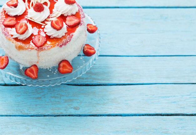 Torta alle fragole su fondo di legno blu