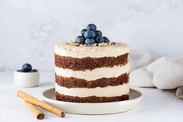 Torta di carote con crema di cocco noci e uvetta su un piatto Zucchero senza glutine vegano senza lattosio