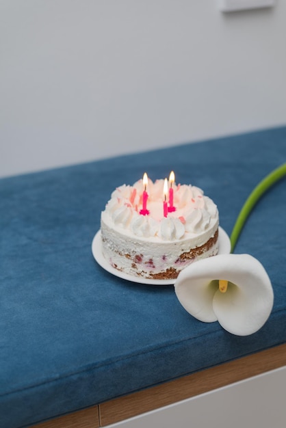 Torta di compleanno con candele rosa Torta di formaggio con lamponi